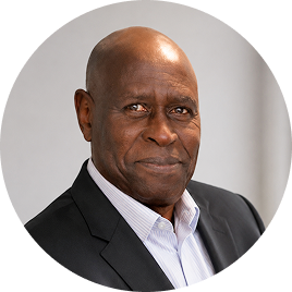 Professional headshot of a man wearing a black blazer