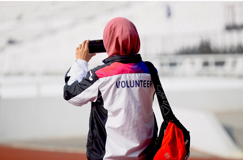 Volunteer taking a photo outdoors